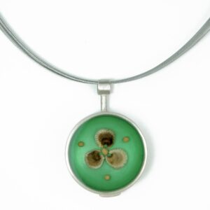Round pendant: seeds on teal